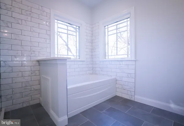 a bathroom with a bathtub and window