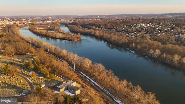 an aerial view of lake and residential houses with outdoor space