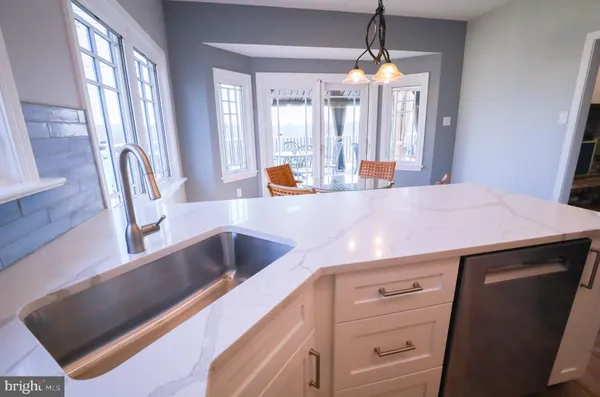 a view of a kitchen counter space and windows