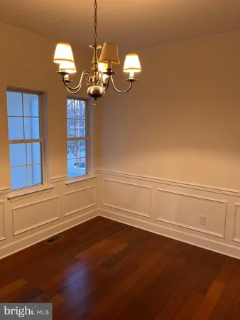 a view of a chandelier fan and wooden floor