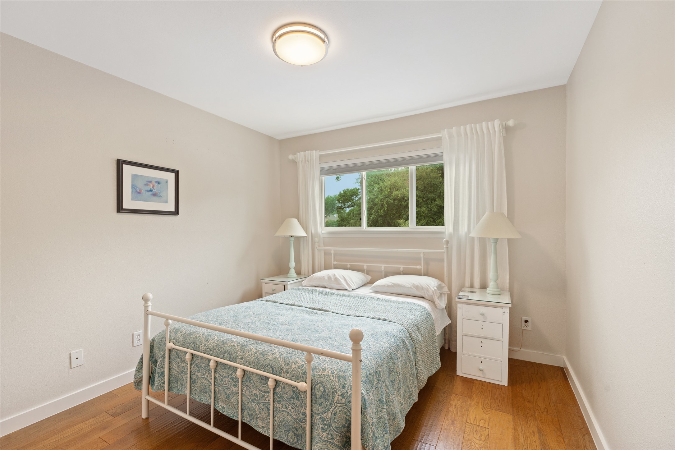 3467 North Hills Drive Austin, TX 78731 - Photo 30 of 40 a bedroom with a bed and wooden floor