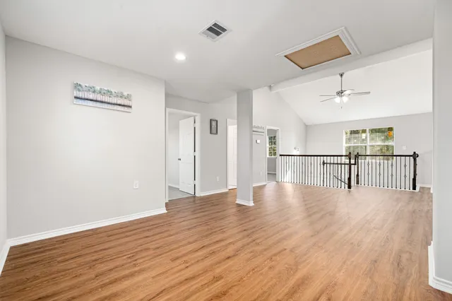 a bedroom with a bed and ceiling fan