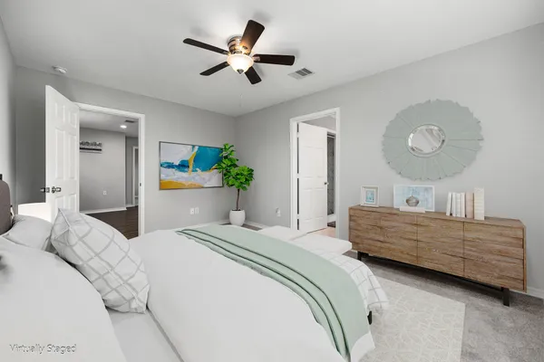 a bedroom with a bed and ceiling fan