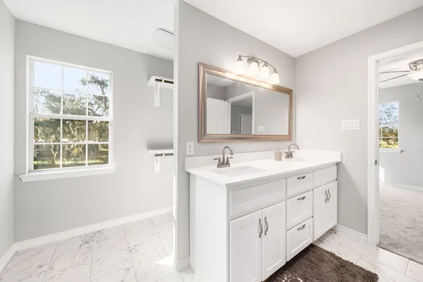 a bathroom with a double vanity sink and a mirror