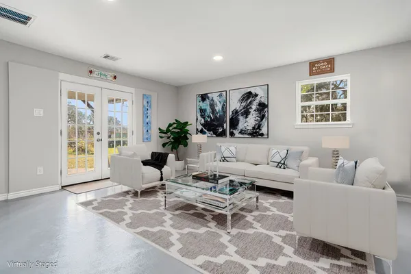 a living room with furniture and a large window