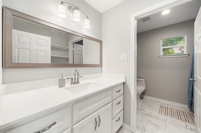 a view of a backyard with a garden and chairs