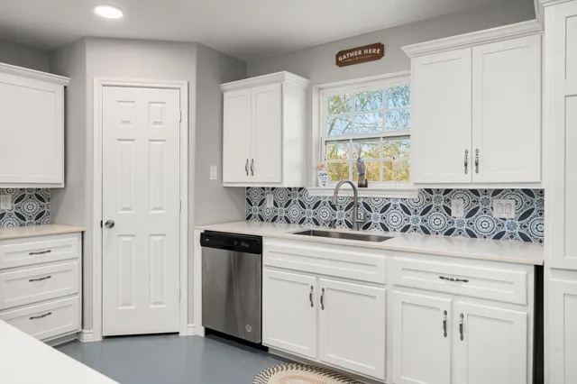 a view of a sink and cabinets