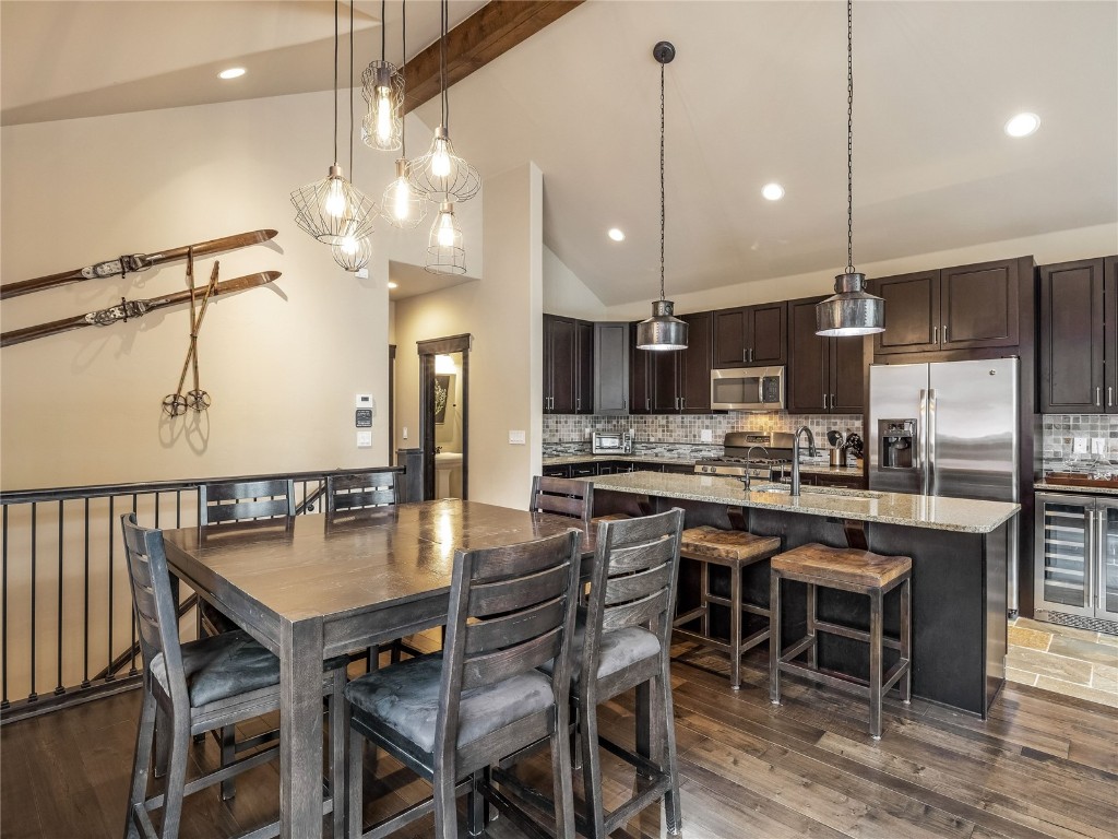 68 Independence Lane Keystone, CO 80435 - Photo 13 of 43 a kitchen with kitchen island a dining table chairs stainless steel appliances and cabinets
