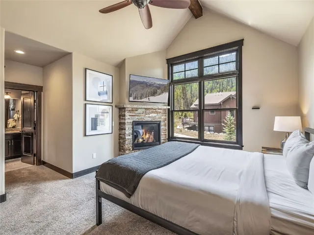 a bedroom with a large bed and a chandelier