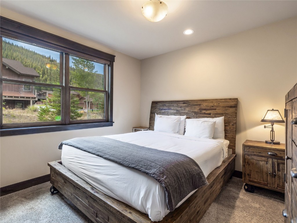 68 Independence Lane Keystone, CO 80435 - Photo 27 of 43 a bedroom with a bed lamp and window