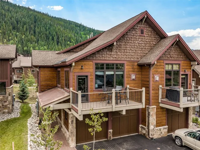 an aerial view of a house with swimming pool and mountains