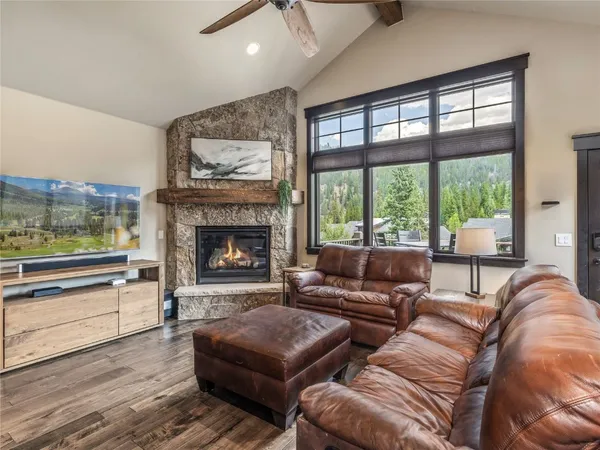 a kitchen with granite countertop a table chairs stainless steel appliances and cabinets
