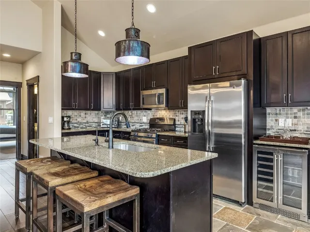 a kitchen with a stove a sink and a refrigerator