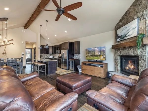 a kitchen with a stove a kitchen island a dining table and chairs