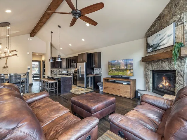 a kitchen with a stove a kitchen island a dining table and chairs