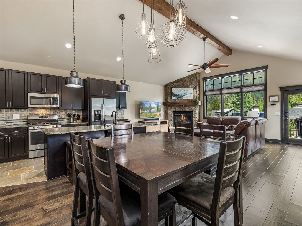 68 Independence Lane Keystone, CO 80435 - Photo 10 of 43 a kitchen with a dining table chairs stainless steel appliances and cabinets