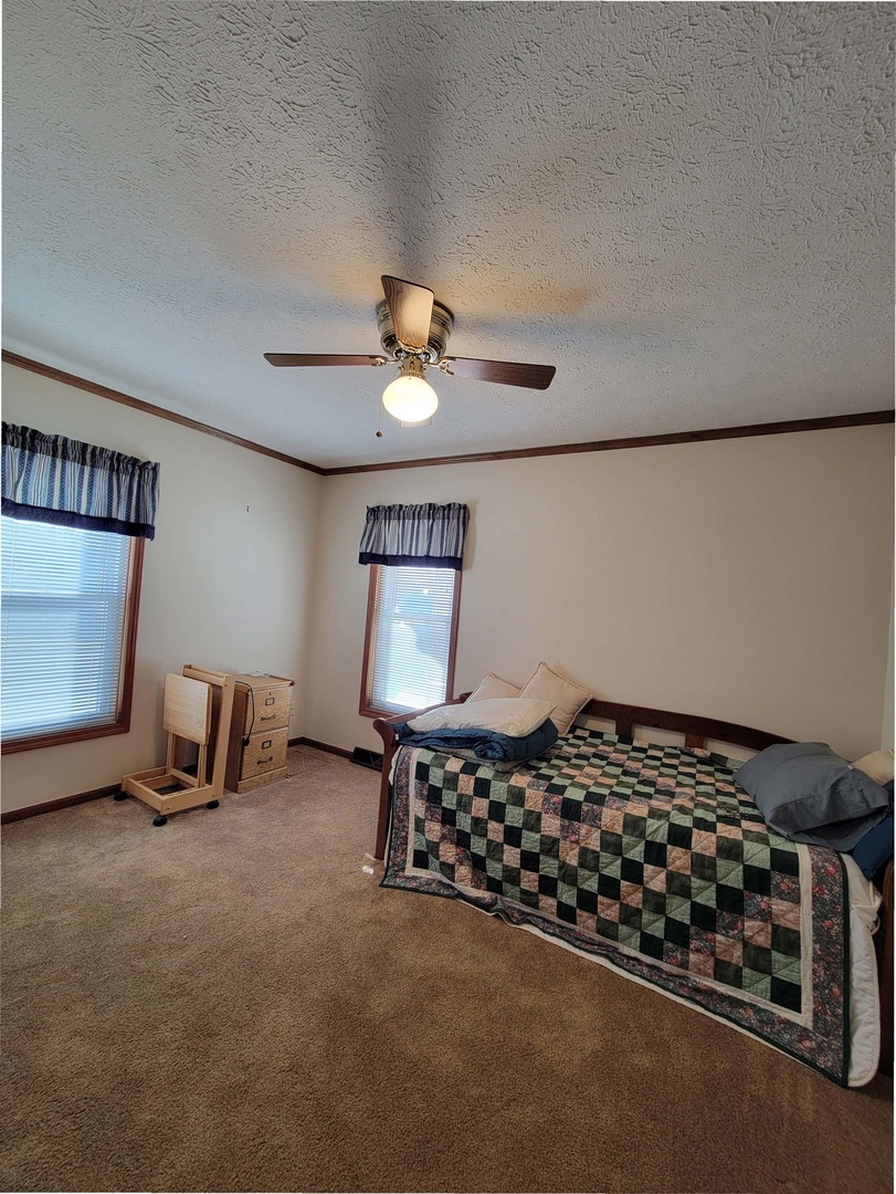 5016 West Colonial Drive, Unit 317 Monee, IL 60449 - Photo 11 of 32 a bed room with a bed and a chair