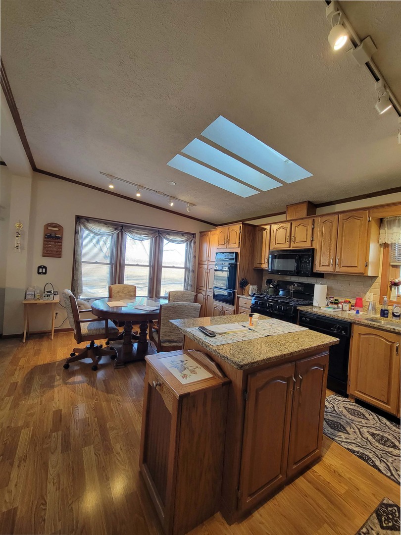 5016 West Colonial Drive, Unit 317 Monee, IL 60449 - Photo 14 of 32 a kitchen with sink and view of living room