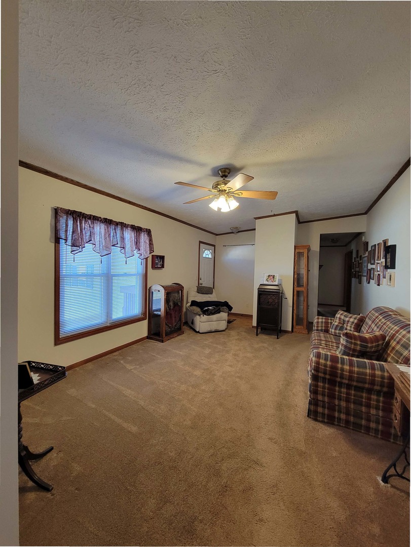 5016 West Colonial Drive, Unit 317 Monee, IL 60449 - Photo 4 of 32 a living room with furniture a projector and a flat screen tv