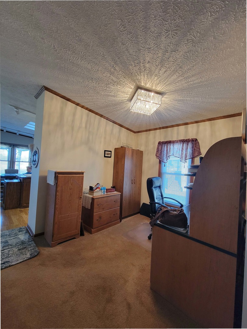 5016 West Colonial Drive, Unit 317 Monee, IL 60449 - Photo 5 of 32 a room with furniture and a chandelier
