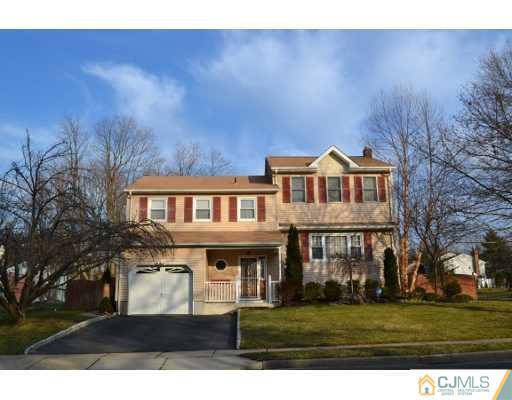 8 Roxy Avenue Edison, NJ 08820 - Photo 1 of 22 a view of a big house with a big yard and large trees