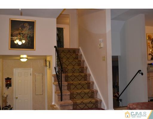 8 Roxy Avenue Edison, NJ 08820 - Photo 15 of 22 a view of a hallway with wooden floor and a living room
