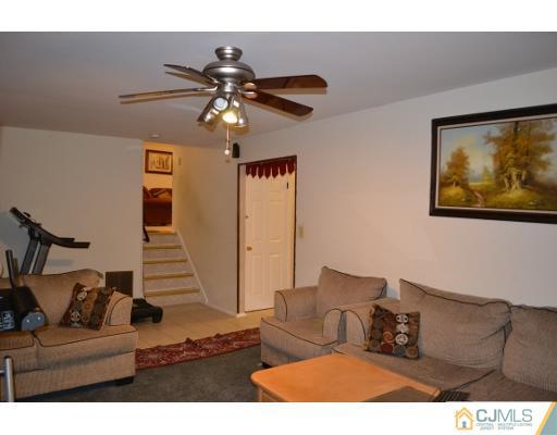 8 Roxy Avenue Edison, NJ 08820 - Photo 20 of 22 a living room with furniture and a ceiling fan