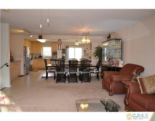 8 Roxy Avenue Edison, NJ 08820 - Photo 10 of 22 a living room with furniture a dining table and kitchen view