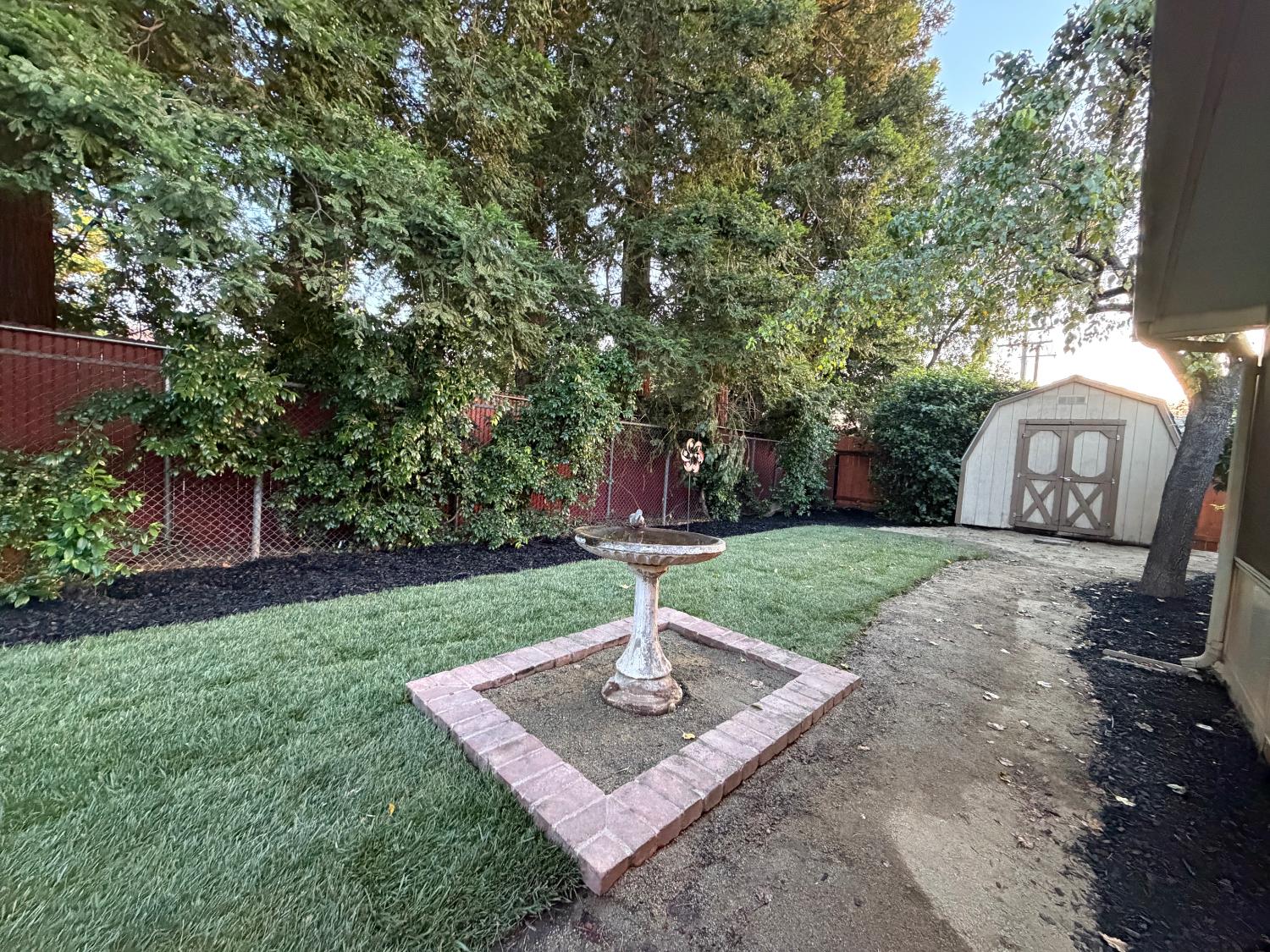 5706 Jeff Way Carmichael, CA 95608 - Photo 20 of 48 Updated landscaping, irrigation system and storage shed. Side yards feature D.G.on walking gate side and rock on opposite side. Summer days in this yard are no problem as the redwoods on the elementary school fence line provide plenty of shade.