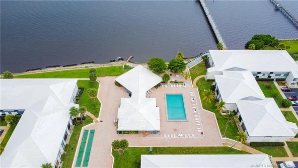 an aerial view of a house with a garden and swimming pool