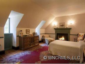 324 Vanderbilt Road Asheville, NC 28803 - Photo 11 of 16 a bed room with a bed and a fireplace