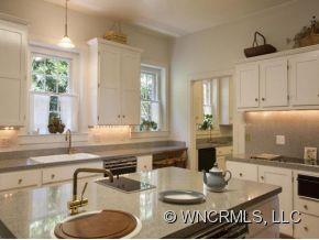 324 Vanderbilt Road Asheville, NC 28803 - Photo 4 of 16 a kitchen with sink granite counter top space and living room