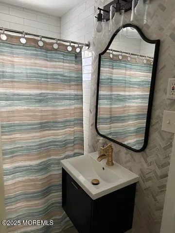 a bathroom with a sink a vanity and a mirror