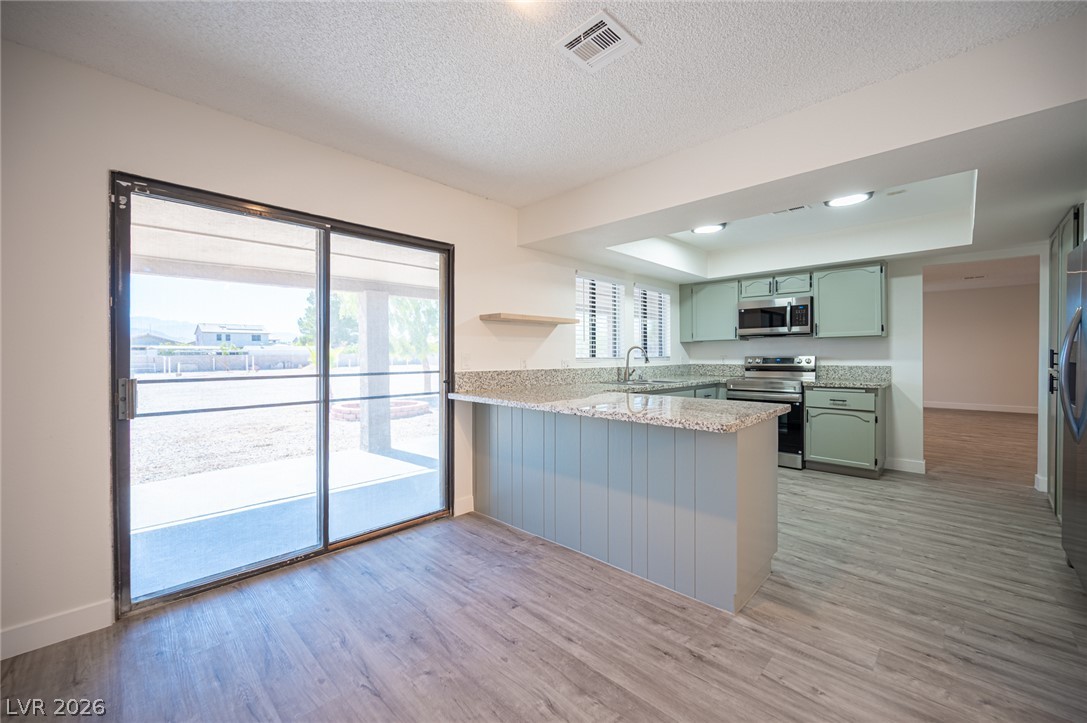 7041 North Decatur Boulevard Las Vegas, NV 89131 - Photo 10 of 33 A well-appointed kitchen featuring sleek countertops, modern appliances, and a seamless connection to outdoor living.