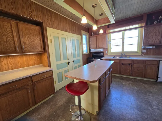 a kitchen with a sink a counter space and appliances