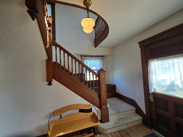 a view of staircase with wooden floor and a window