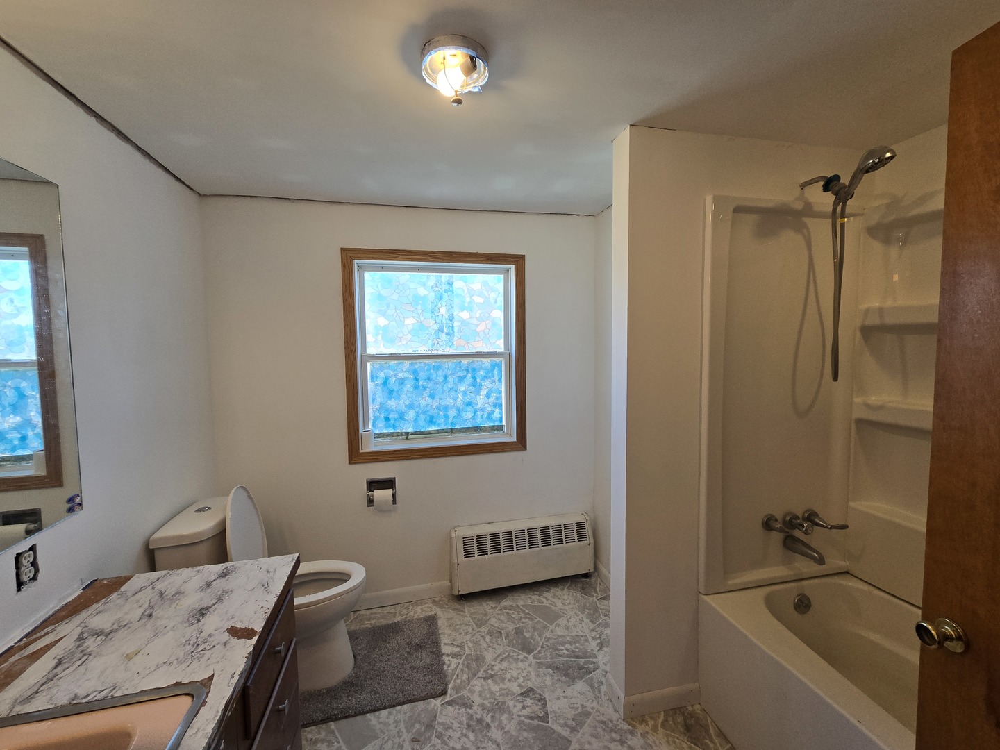 516 East Buffalo Street Polo, IL 61064 - Photo 27 of 28 a bathroom with a granite countertop sink a toilet and shower