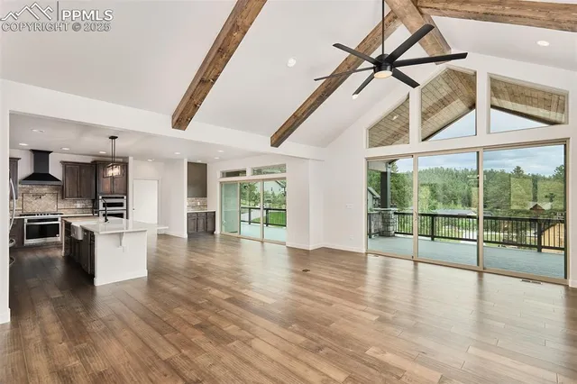 a view of a livingroom with wooden floor and furniture