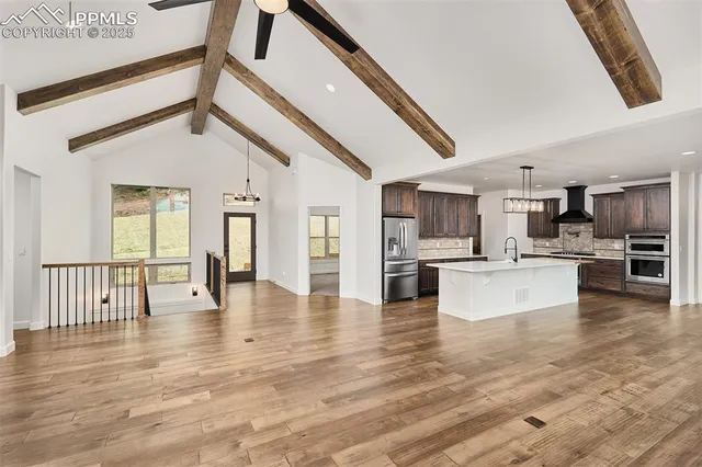 a view of kitchen with kitchen island sink and wooden floor