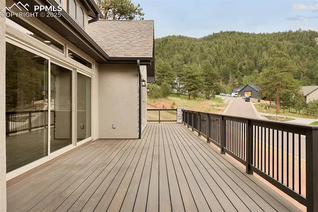 a view of a balcony with wooden floor and fence