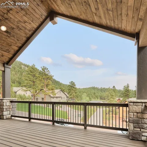 a view of balcony with wooden floor and fence