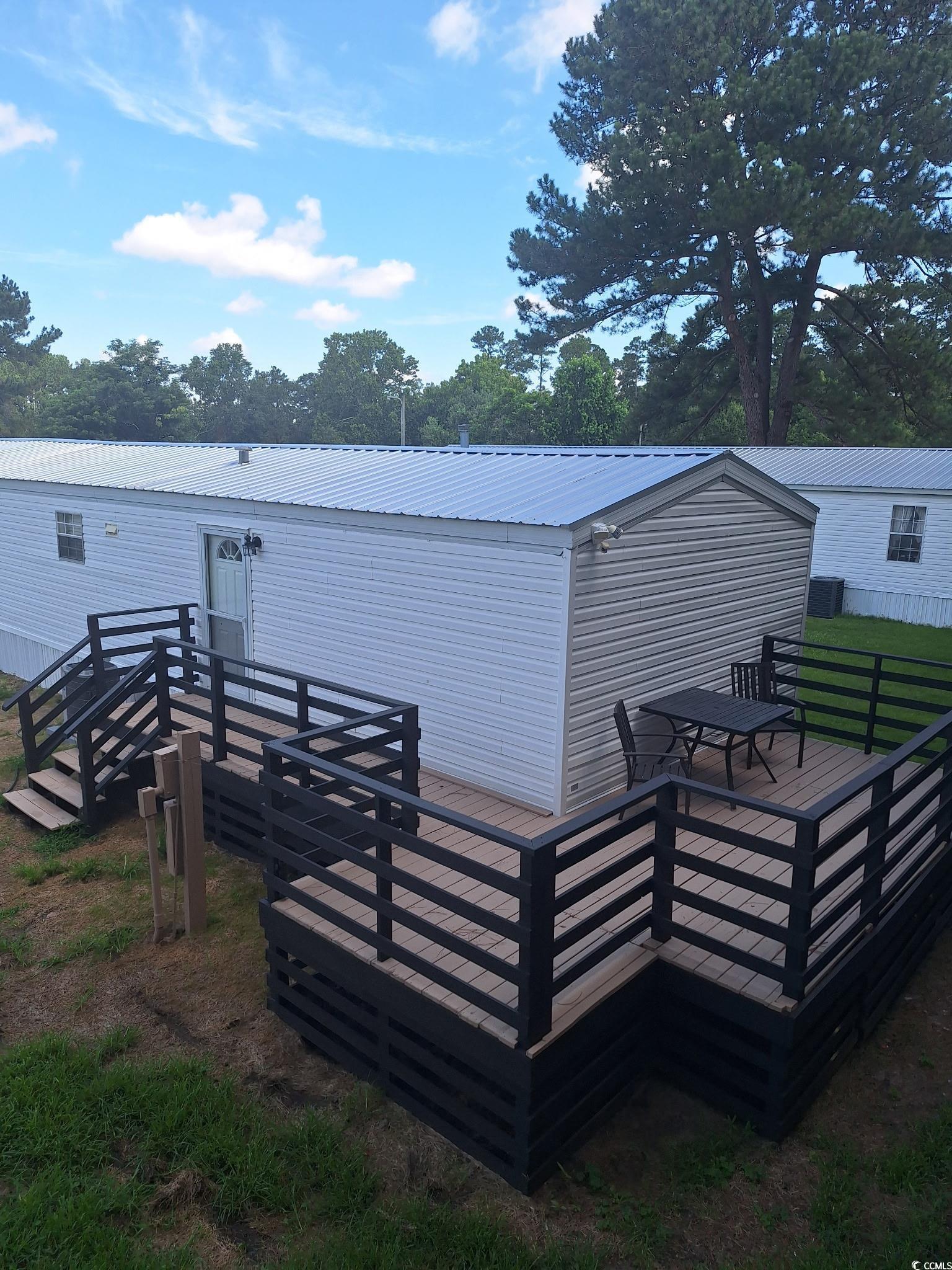 5540 Old Woods Road Myrtle Beach, SC 29588 - Photo 4 of 25 Rear view of house with a metal roof