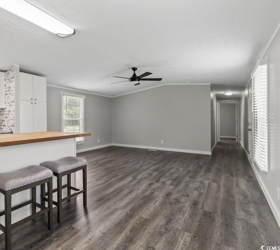5540 Old Woods Road Myrtle Beach, SC 29588 - Photo 10 of 25 Living room featuring dark wood finished floors, ceiling fan, and ornamental molding