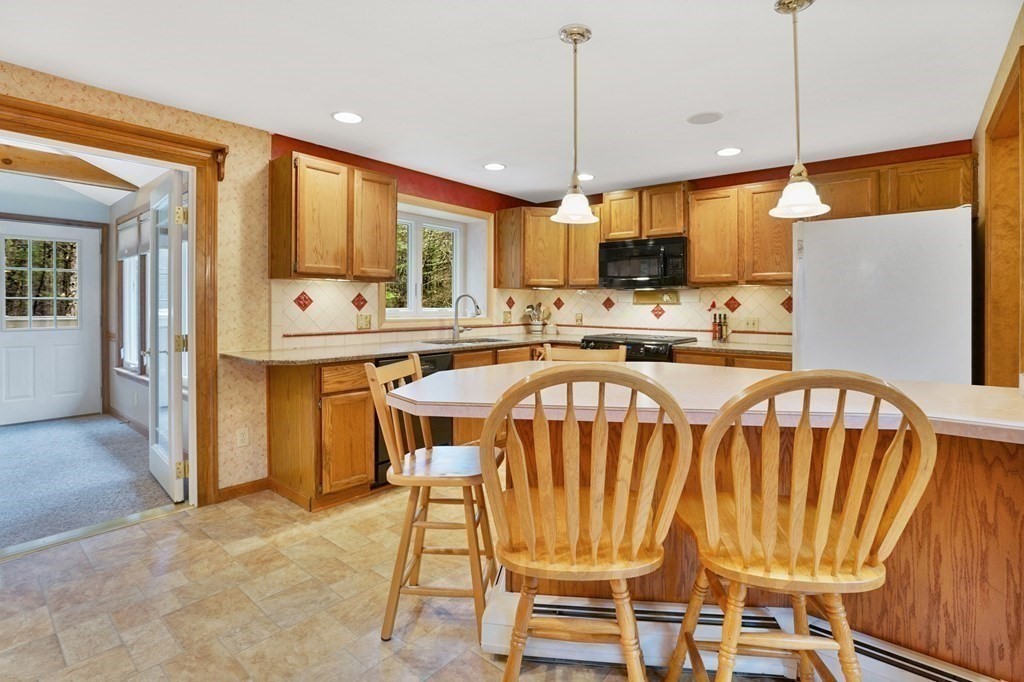 17 Pequot Road Southampton, MA 01073 - Photo 16 of 41 a dining room with a table chairs and a kitchen view