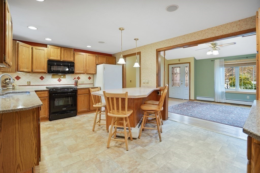 17 Pequot Road Southampton, MA 01073 - Photo 17 of 41 a view of a dining room with furniture and a kitchen