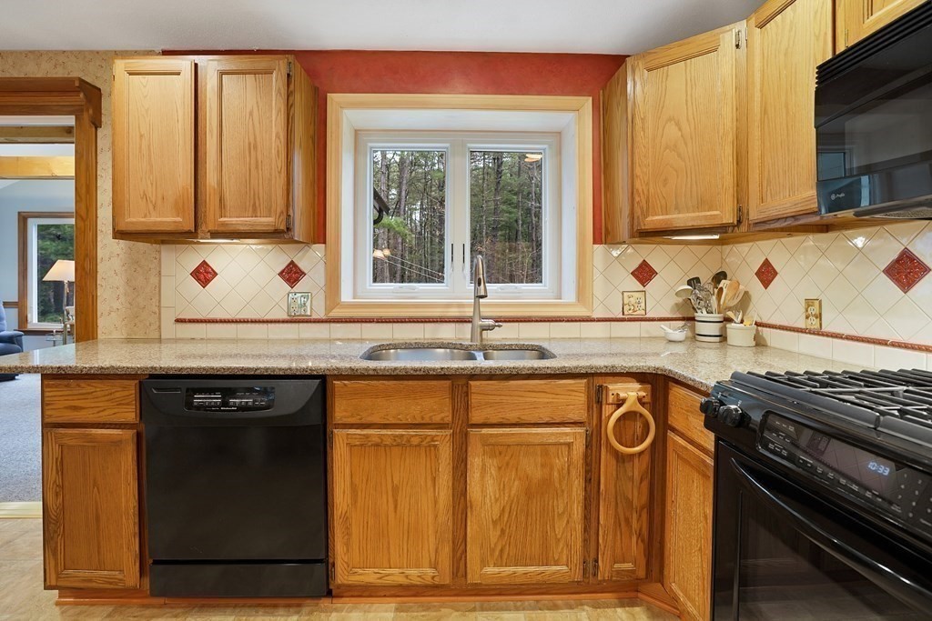 17 Pequot Road Southampton, MA 01073 - Photo 18 of 41 a kitchen with stainless steel appliances granite countertop a sink stove and cabinets