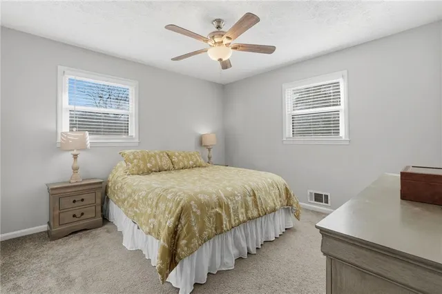 a bedroom with a bed and a mirror on dresser