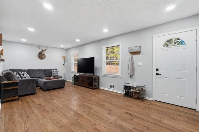 a living room with furniture and a flat screen tv
