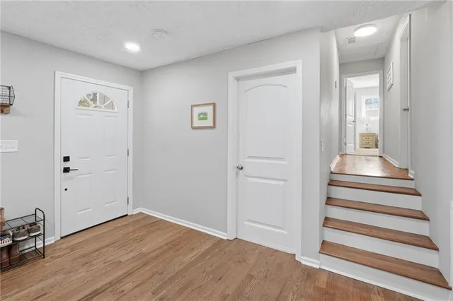 a kitchen with stainless steel appliances granite countertop a refrigerator a stove and a sink