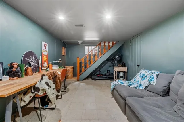 a living room with furniture and stairs